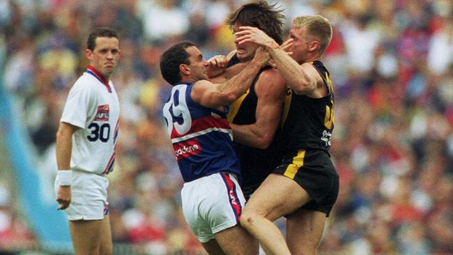 Wayne Campbell and Matthew Knights clash with Tony Liberatore.