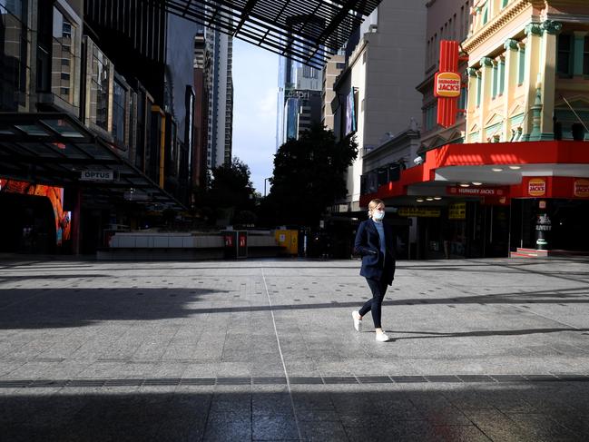 BRISBANE, AUSTRALIA - NewsWire Photos - JULY 1, 2021.A masked woman walks through an empty Queen Street Mall in central Brisbane. Queensland has gone into a 3-day lockdown due to a recent Covid outbreak.Picture: NCA NewsWire / Dan Peled