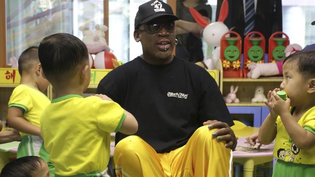 Dennis Rodman sits with children from the Pyongyang orphanage and nursery. Picture: AP Photo/Kim Kwang Hyon