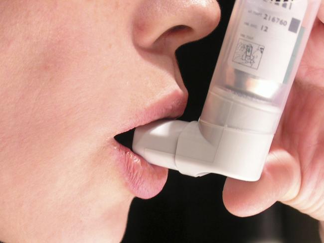 Generic photo of a person using an inhaler for asthma