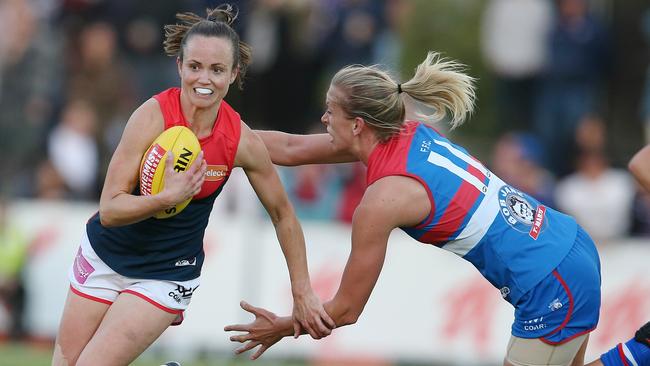 AFLW. Round 3. Western Bulldogs vs Melbourne at the Whitten Oval. Daisy Pearce brushes past Lauren Spark . Pic: Michael Klein