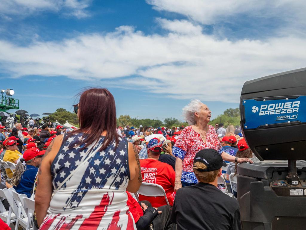 A supporter of Republican presidential candidate, former US President Donald Trump keeps cool ahead of the former president's arrival during a campaign rally. Picture: Getty Images via AFP