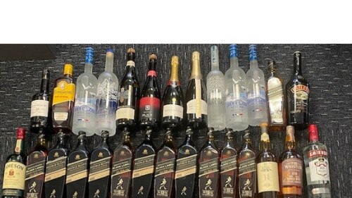 Police found 50 bottles of allegedly stolen alcohol at an Adelaide home. Picture: SAPOL