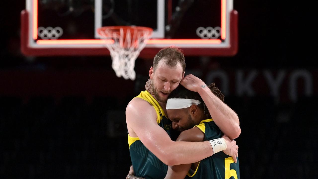 Joe Ingles and Patty Mills embrace after the Boomers beat Slovenia. Picture: Aris Messinis / AFP