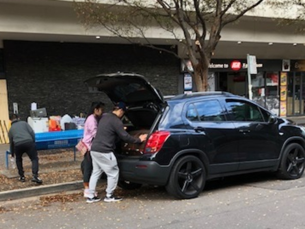 Residents pack the boot of a car after being given a short window to gather their belongings. Picture: Phoebe Loomes