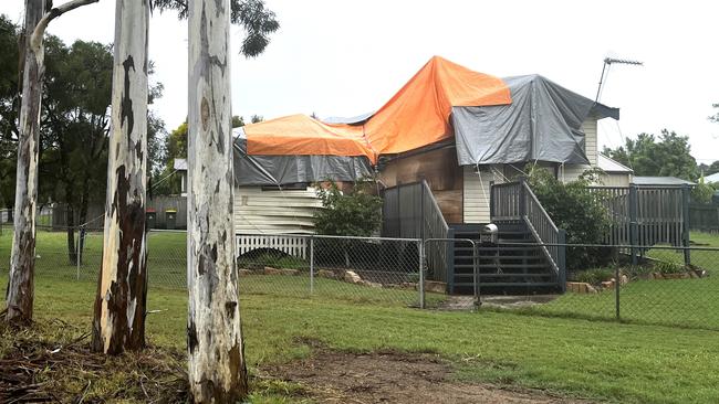 Two months later, the home on Haly Street is still damaged and covered in tarps.
