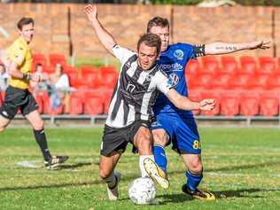 TIGHT TUSSLE: Willowburn's Daniel Saunders (left) shields the ball from USQ FC's Brendan Willmot during their President's Cup Clash. Willowburn won the game 8-7 on penalties after the game finished 2-2. Picture: paulsmith:photographer