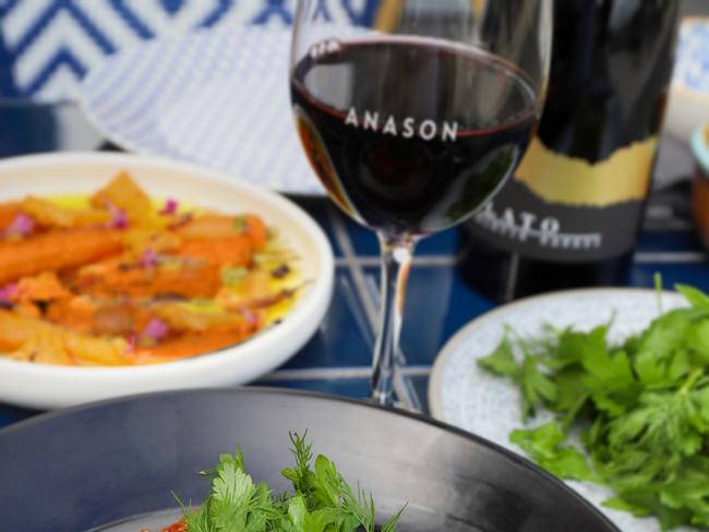 A 10-dish feast with a glass of wine served at Anason. Picture: Jenifer Jagielski