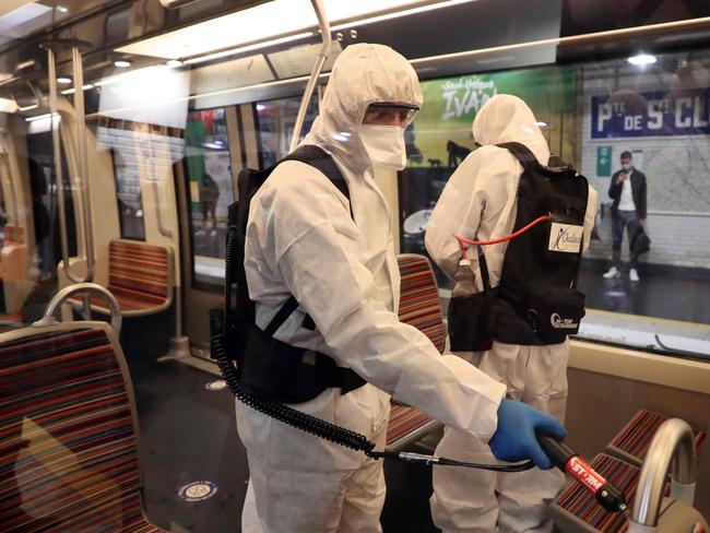 Cleans spray down a metro train in Paris. New coronavirus cases have grown again in France. Picture: AFP