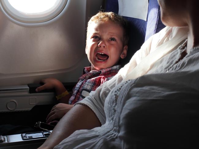 little boy in the plane looking out the window