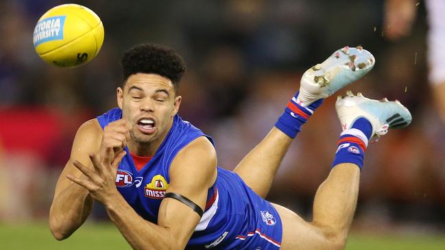 Jason Johannisen fires out a diving handball. Picture: Michael Klein.