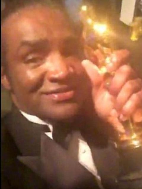 Pictured with an Oscar statue.