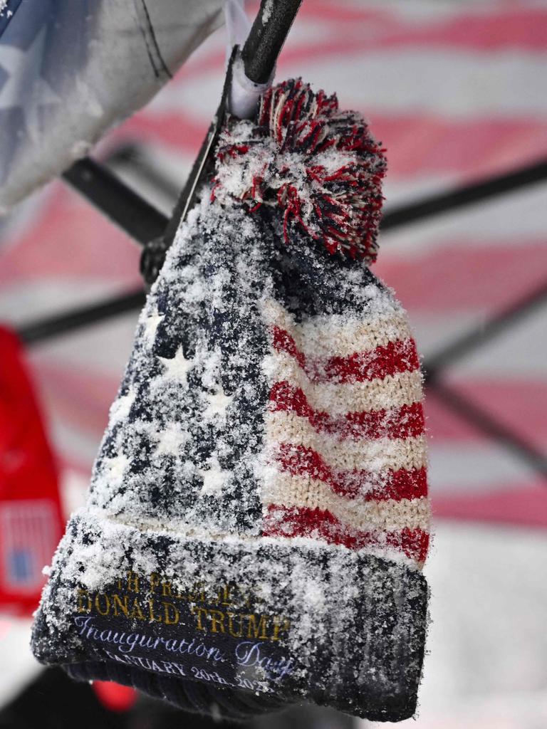 A frozen hat covered in snow is seen at a memorabilia vendor stand in Washington, DC. (Photo by ANGELA WEISS / AFP)