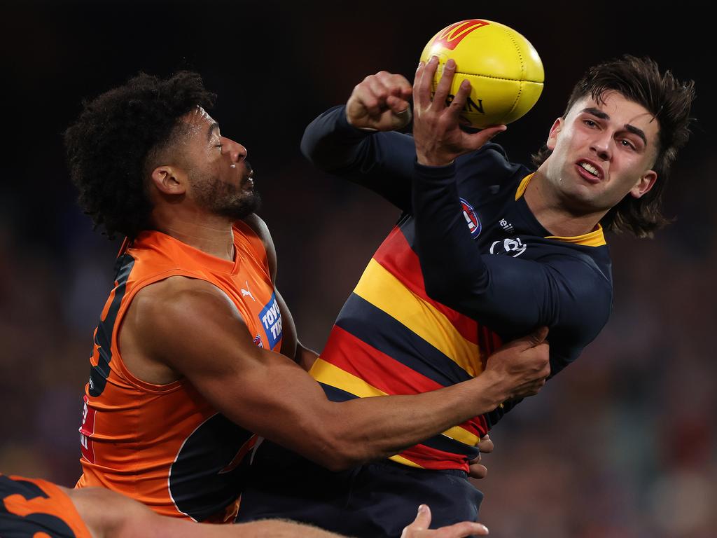 ADELAIDE, AUSTRALIA – JULY 15: Josh Rachele of the Crows handpasses the ball from Connor Idun of the Giants during the 2023 AFL Round 18 match between the Adelaide Crows and the GWS Giants at Adelaide Oval on July 15, 2023 in Adelaide, Australia. (Photo by Sarah Reed/AFL Photos via Getty Images)