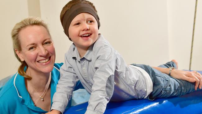 Kid Sense Child Development founder and executive director clinical operations Joanna Buttfield with client Jude Hepworth-Smith, 3 who has hearing loss, impaired vision and sensory processing disorder. Picture: Keryn Stevens/AAP Image