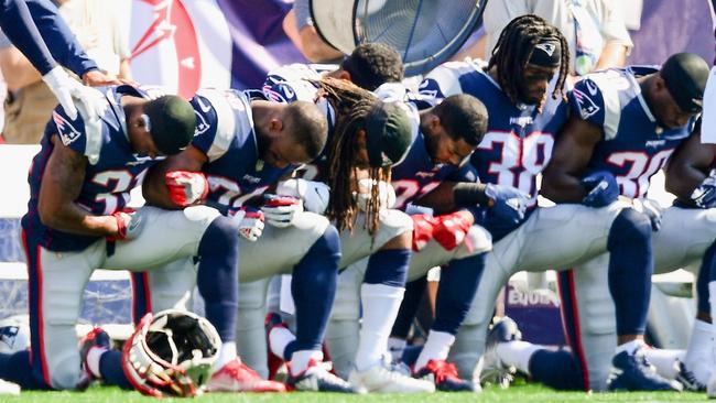 Members of the New England Patriots kneel on the sidelines as the National Anthem is played before a game against the Houston Texans. Picture: AFP