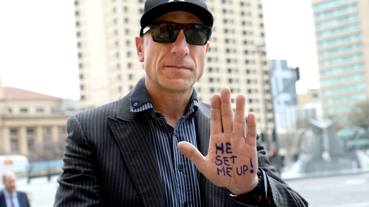 Polites family member Markas Salkanovic arrives at the Adelaide Magistrates Court in 2016 with He Set Me Up written on his hand. Picture: Greg Higgs