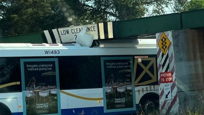 Emergency services arrived to the scene of a Translink bus lodged under a major Graceville bridge on Tuesday afternoon.