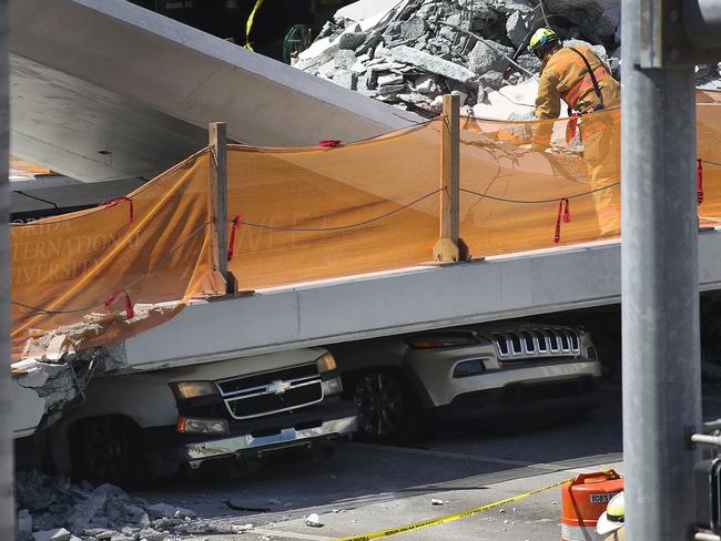 At least eight vehicles were smashed by the new construction over southwest 8th street. Picture: Raedle/Getty Images/AFP