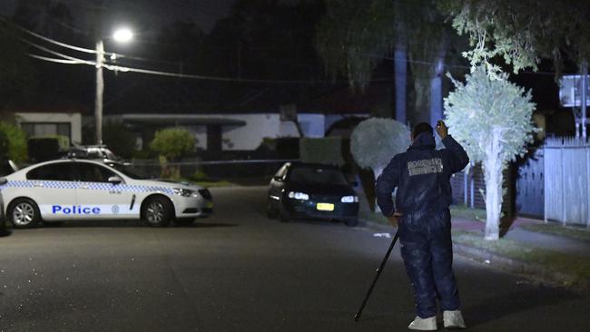 Forensic teams and police at the scene of the shooting in Cabramatta on Saturday night. Picture: Gordon McComiskie