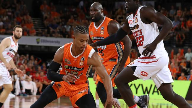 Scott Machado and Nate Jawai of the Cairns Taipans with Damian Martin and Majok Majok of the Perth Wildcats during the second NBL Semi-Final match between the Cairns Taipans and the Perth Wildcats at the Cairns Convention Centre in Cairns, Sunday, March 1, 2020. (AAP Image/Marc McCormack)