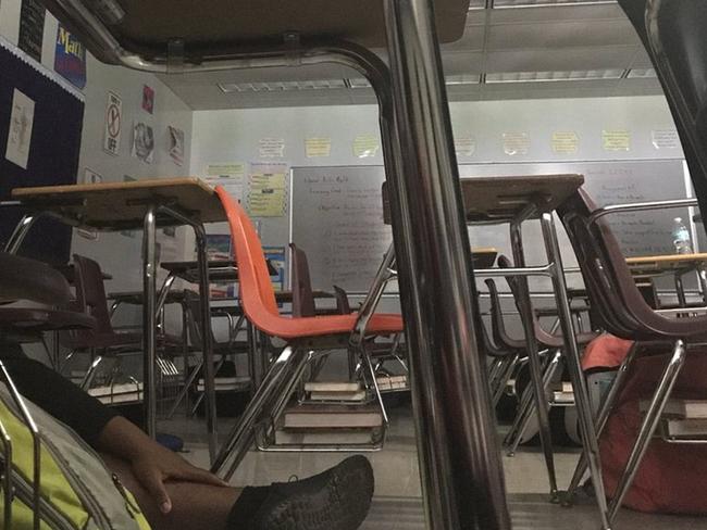Students hide under chairs and tables after a shooter began firing at Marjory Stoneman Douglas High School. Picture: Supplied/Twitter