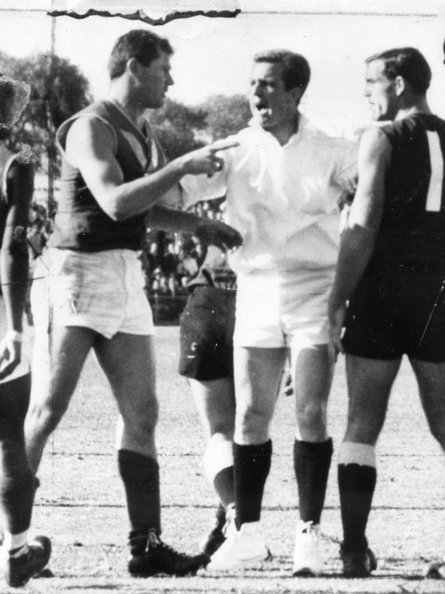 Ken Cunningham intervenes between South Adelaide’s Neil Kerley and West Torrens’ Neil Hawke.