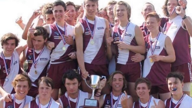 Nick Lowden with his Traralgon football team.