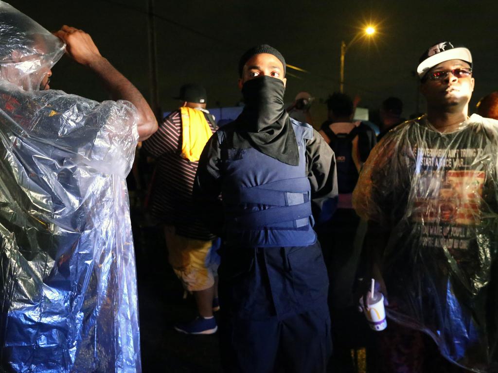 A member from the New Black Panther moment wears a mask and bullet proof vest during the protest.