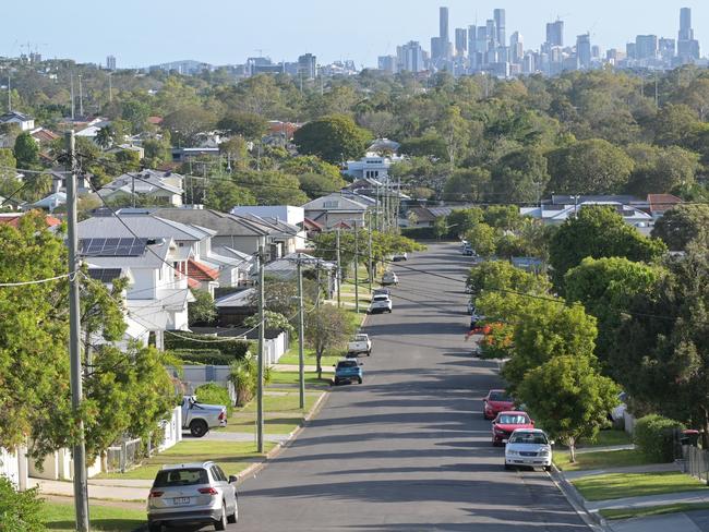 Brisbane - Nov 18 2023:Residential houses street against Brisbane City skyline.Home prices across Australia have hit new highs, with the median value of a home in a capital city shooting to $832,000. housing suburbs generic