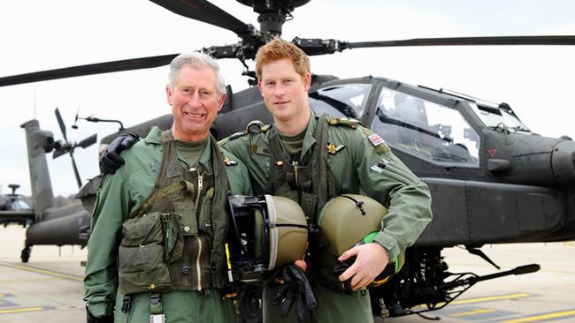 Charles, former Prince of Wales, and Prince Harry in front of an Apache Helicopter in 2011. Picture: Richard Dawson/MoD via Getty Images