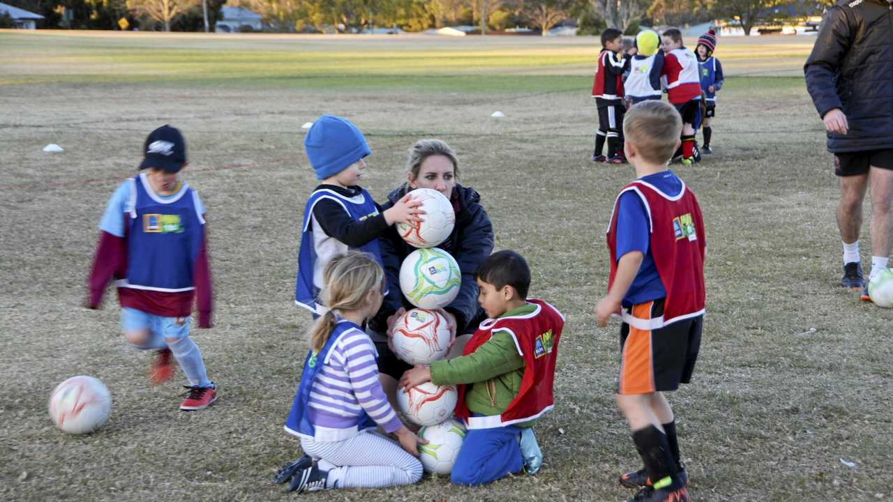 Football Queensland female participation officer Kerry Hammersley participates in a fun exercise with junior players. Picture: Jason Gibbs