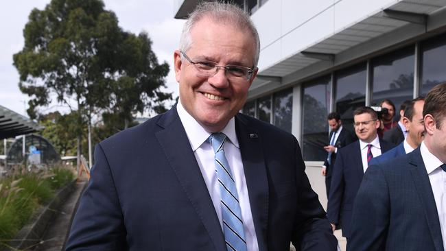 Prime Minister Scott Morrison shows off a Cronulla Sharks NRL tie during a infrastructure press conference at Macquarie Park. (AAP Image/Joel Carrett)