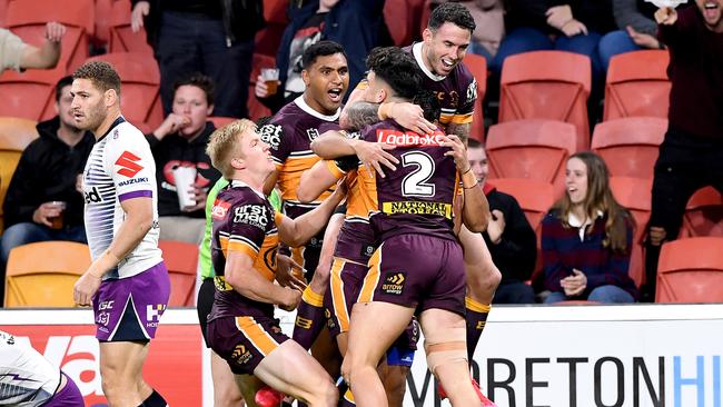 Herbie Farnworth is mobbed by teammates after scoring against the Storm in 2020. Picture: Bradley Kanaris/Getty Images.