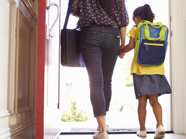 Close Up Of Mother And Daughter Leaving For School