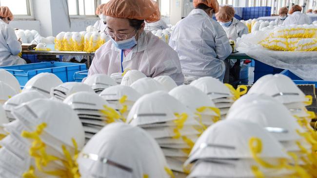 China is now manufacturing and shipping hundreds of thousands of masks around the world to help combat the spread of coronavirus. Picture: STR/AFP