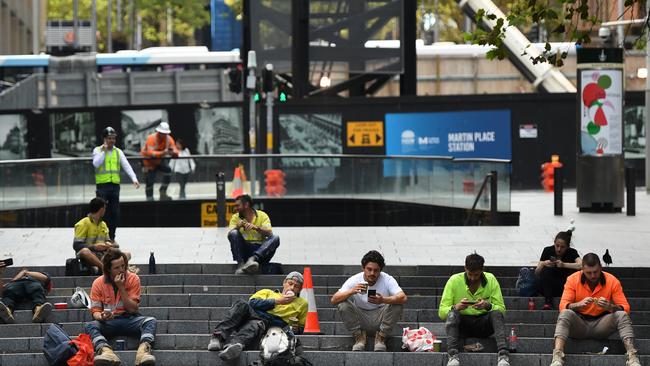 Trade workers seen having lunch at Martin Place in Sydney, Tuesday, March 24, 2020. Picture: AAP