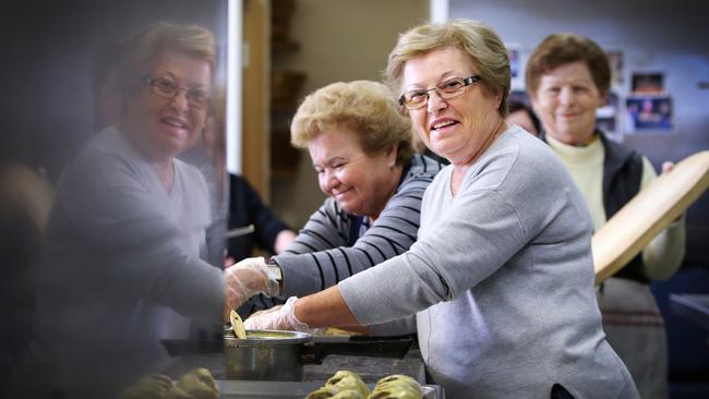 The Greek community is coming together to cook for a dinner to announce plans that Voula Delios's former grocery store will be converted into a food collective in North Hobart. Preparing the food are from left, Sasa Psangaris, Pitsa Dritas and Diamando Venetsanakos. Picture: CHRIS KIDD