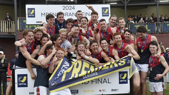 Mt Eliza show off their premiership cup and flag. Picture: Andrew Batsch