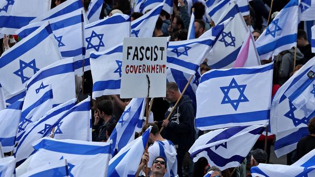 Protesters wave Israeli flags during a demonstration against the government's controversial push to overhaul the justice system. Picture: AFP.