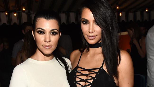 Kim Kardashian, right, with her sister Kourtney (left) has been showing off her slimmed down figure since the birth of her second baby, Saint. Picture: Splash