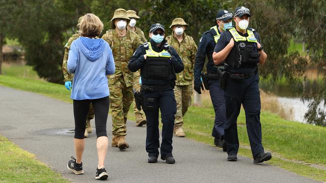 Police and troops patrol the banks of the Yarra River in Melbourne. Picture: Getty Images