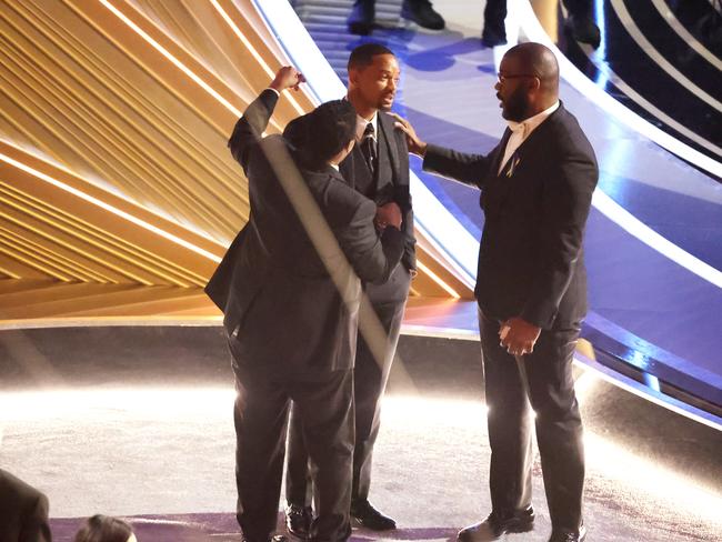 Denzel Washington and Tyler Perry comfort Will Smith after the infamous slap. Picture: Getty Images