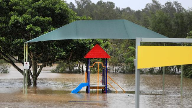 Lakewoods reserve on 19th Avenue Elanora turns into a giant lake flooding the BBQ area and basketball court after torrential rain over night causing the creek to break its banks. NCA NewsWire / Scott Powick