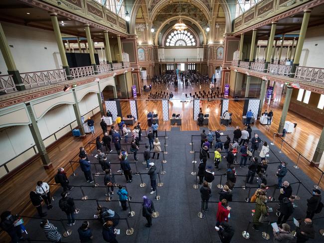 People wait to be register their information before being vaccinated at the Royal Exhibition Building COVID-19 Vaccination Centre in Melbourne. Picture: Getty Images