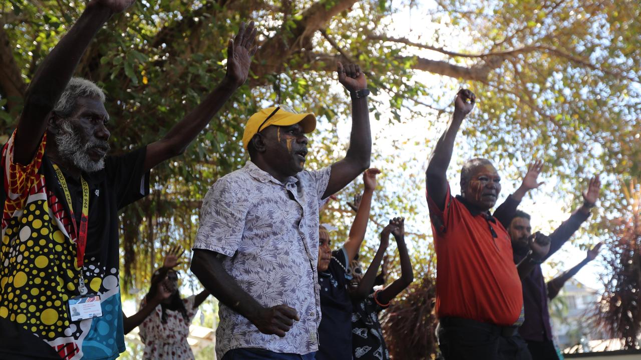 Senior Munupi man Mr Tungatulum (in orange) leads family members in a performance of a Jorrigjorringa (kookaburra) song outside Darwin Local Court following the death in care coronial for 47-year-old Pukumani Alimankinni, on April 24, 2024. Picture: Zizi Averill