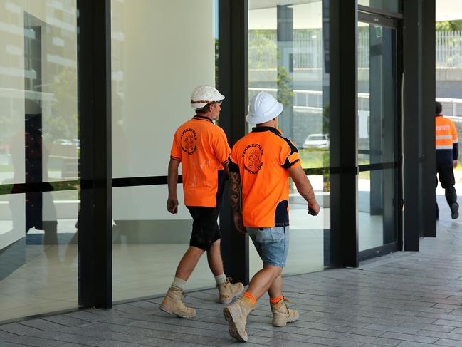 Tradies outside the Opal Tower at Sydney Olympic Park. Picture: Tim Hunter