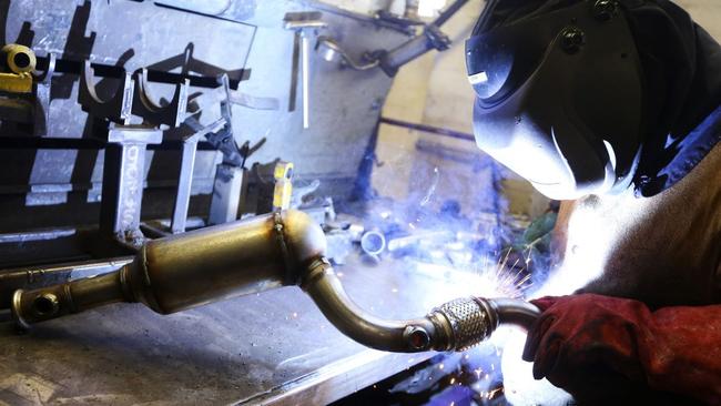 An employee welds parts onto an car catalytic converter emission control device. There have been a series of thefts of converters from cars across Knox.