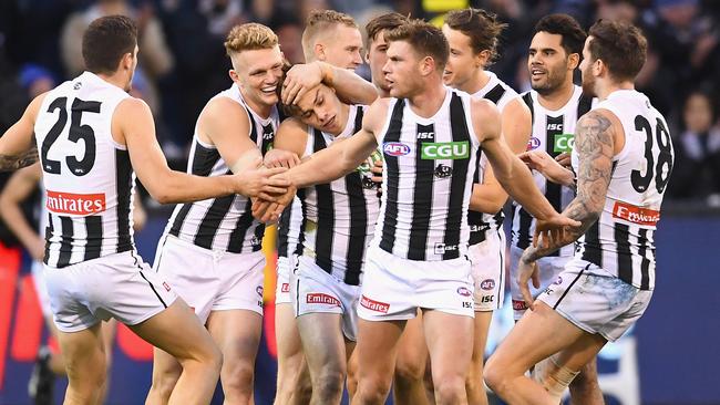 Collingwood players celebrate a goal against Melbourne. Picture: Getty Images