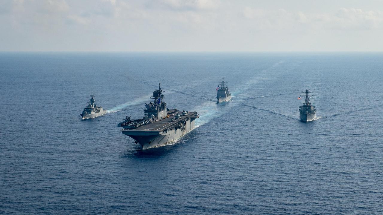 (L-R) Royal Australian Navy helicopter frigate HMAS Parramatta conducts officer of the watch manoeuvres with amphibious assault ship USS America, guided-missile cruiser USS Bunker Hill and guided-missile destroyer USS Barry in the South China Sea. Picture: Department of Defence